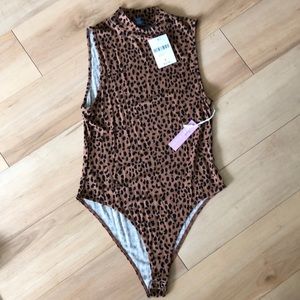 Leopard body suit. New with tags.